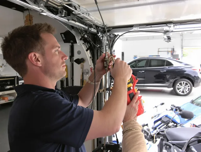 Clinton Garage Door Repair safety certified technician performing cable replacement in Clinton